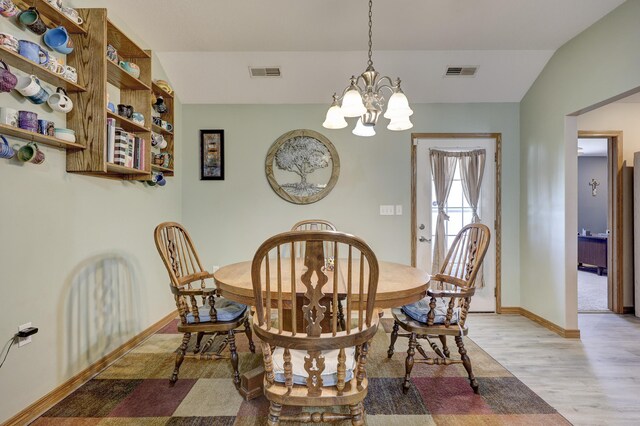 707 Lexie Ln, Carthage, MO 64836 - dining space with light wood-style flooring, a chandelier, and baseboards