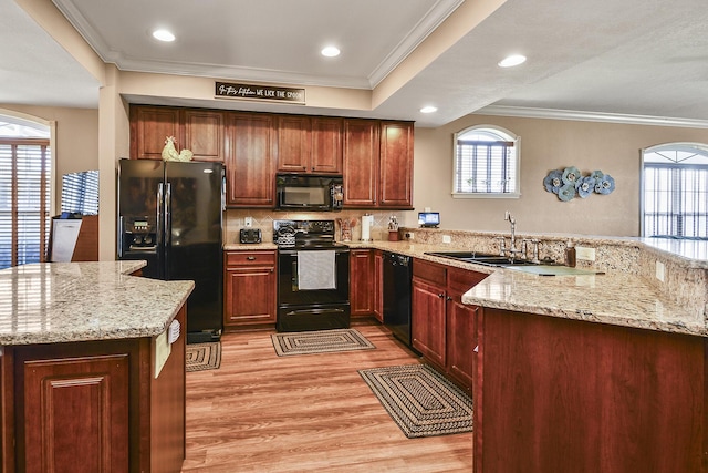 300 Glory Rd, Branson, MO 65616 - kitchen featuring black appliances, a sink, light wood-type flooring, a peninsula, and light stone countertops