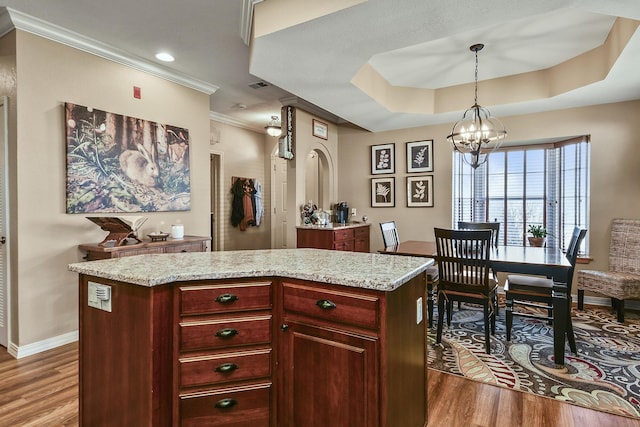 300 Glory Rd, Branson, MO 65616 - kitchen featuring wood finished floors, reddish brown cabinets, baseboards, pendant lighting, and crown molding