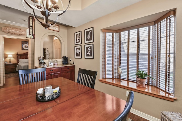 300 Glory Rd, Branson, MO 65616 - dining room with a chandelier, healthy amount of natural light, arched walkways, and wood finished floors
