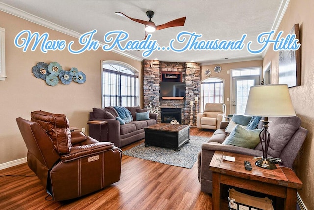 300 Glory Rd, Branson, MO 65616 - living area featuring crown molding, a ceiling fan, wood finished floors, baseboards, and a fireplace