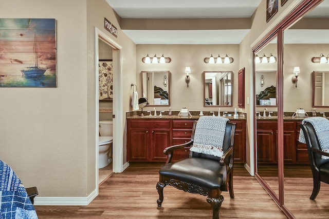 300 Glory Rd, Branson, MO 65616 - full bathroom featuring double vanity, wood finished floors, toilet, and baseboards