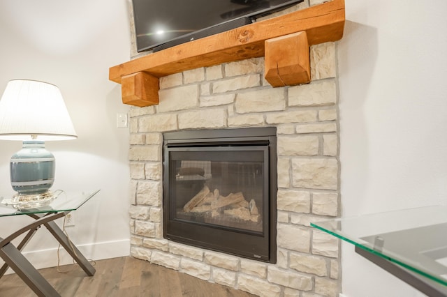 4738 N Florence Ave, Ozark, MO 65721 - detailed view of wood finished floors, a stone fireplace, and baseboards