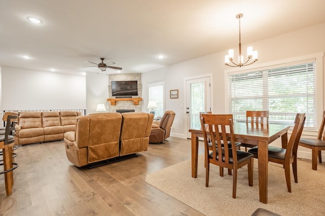 4738 N Florence Ave, Ozark, MO 65721 - dining area with a chandelier, light wood-style flooring, ceiling fan, a fireplace, and recessed lighting