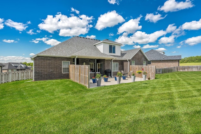 4786 E Whitman Rd, Springfield, MO 65802 - back of property featuring brick siding, a patio, and roof with shingles