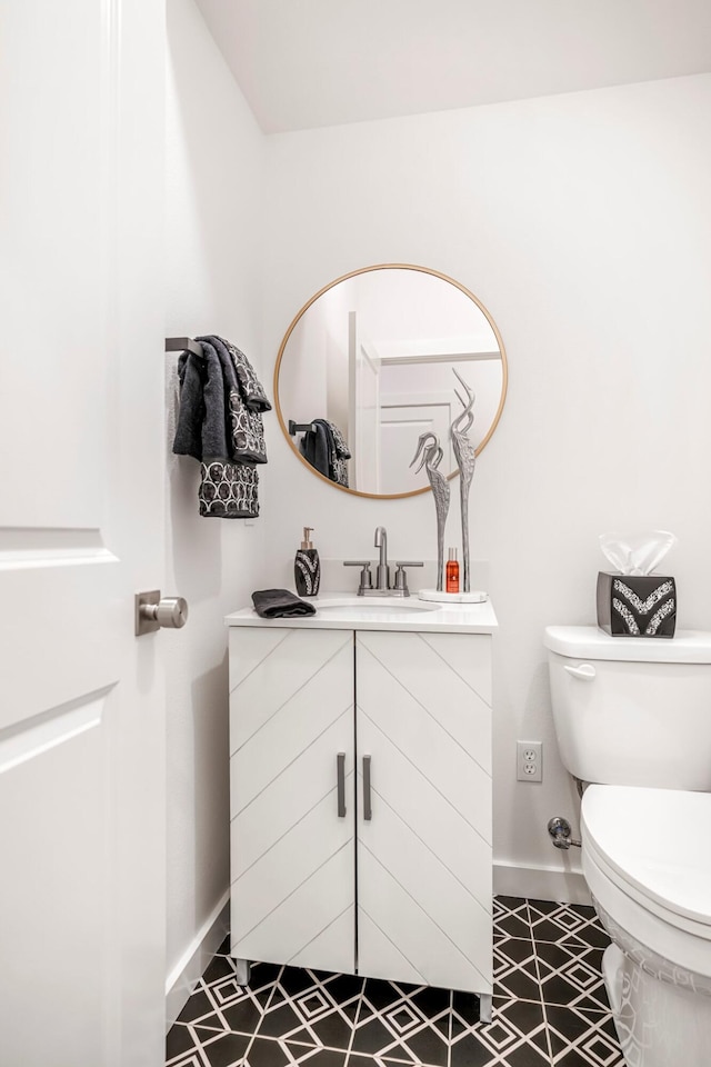 4786 E Whitman Rd, Springfield, MO 65802 - half bathroom with baseboards, vanity, and toilet