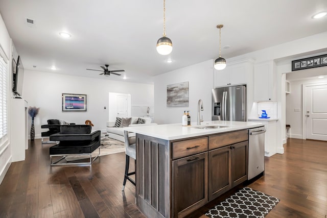 4786 E Whitman Rd, Springfield, MO 65802 - kitchen featuring stainless steel appliances, a sink, light countertops, open floor plan, and dark wood finished floors