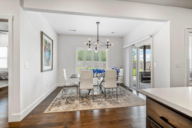 4786 E Whitman Rd, Springfield, MO 65802 - dining area featuring a chandelier, dark wood finished floors, and baseboards