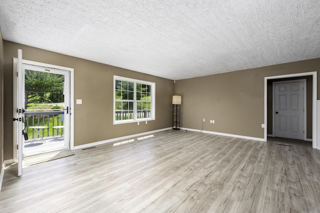 2800 State Highway Bb, Hollister, MO 65672 - unfurnished living room with a textured ceiling, light wood-style flooring, and baseboards