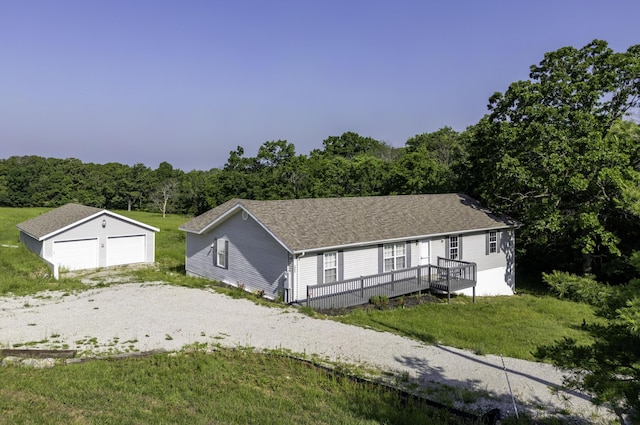 2800 State Highway Bb, Hollister, MO 65672 - view of front facade with a garage, an outbuilding, a front lawn, a wooded view, and a deck