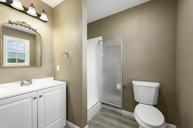 2800 State Highway Bb, Hollister, MO 65672 - bathroom featuring baseboards, a shower stall, toilet, vanity, and wood finished floors