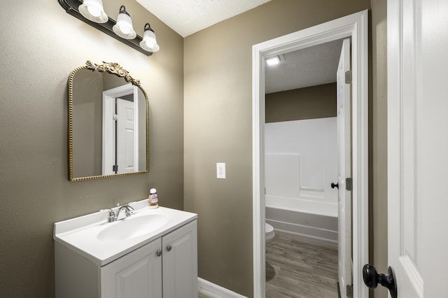 2800 State Highway Bb, Hollister, MO 65672 - full bathroom with vanity, toilet, a tub to relax in, wood finished floors, and a shower