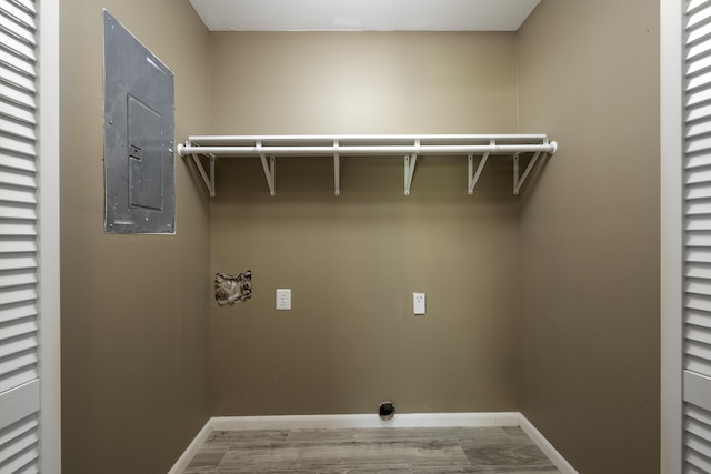 2800 State Highway Bb, Hollister, MO 65672 - laundry room featuring electric dryer hookup, electric panel, wood finished floors, and baseboards