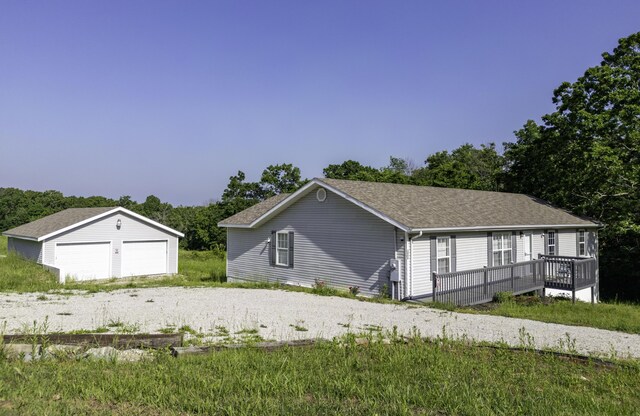 2800 State Highway Bb, Hollister, MO 65672 - view of side of property featuring an outdoor structure, a garage, a wooden deck, and a shingled roof