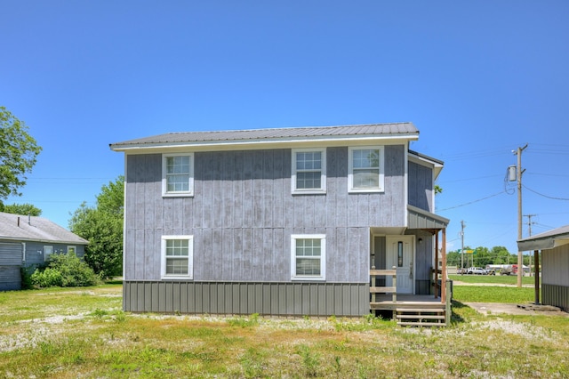 511 N E, Columbus, KS 66725 - back of house featuring metal roof and a yard