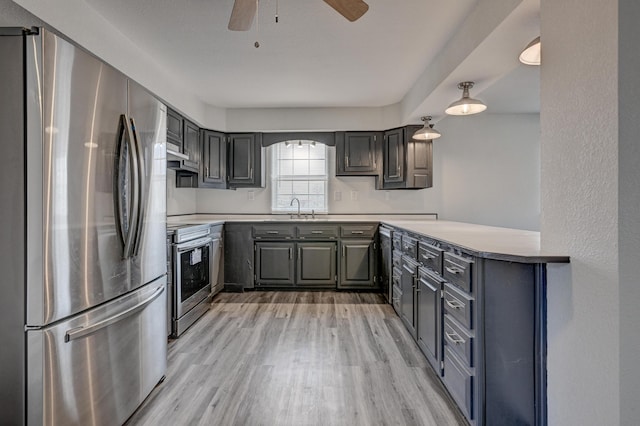 511 N E, Columbus, KS 66725 - kitchen featuring stainless steel appliances, a sink, light wood-style floors, a ceiling fan, and light countertops