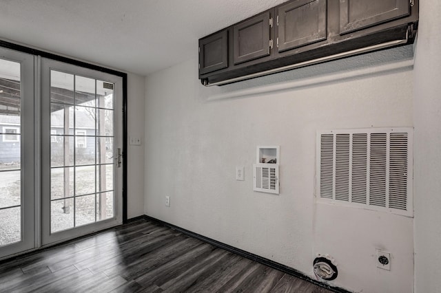 511 N E, Columbus, KS 66725 - washroom featuring electric dryer hookup, cabinet space, dark wood-type flooring, a heating unit, and hookup for a washing machine