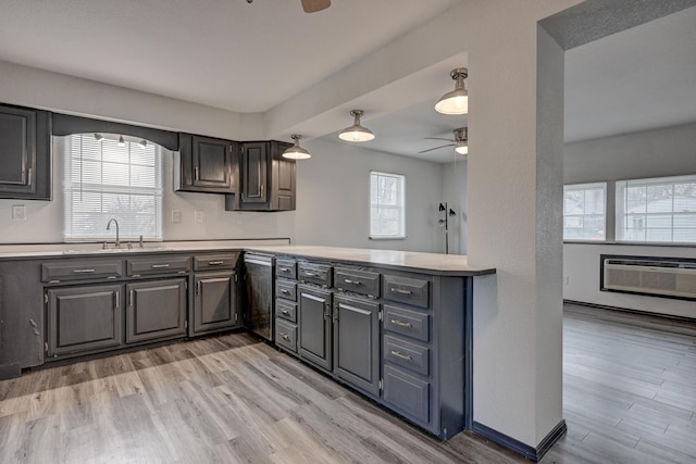 511 N E, Columbus, KS 66725 - kitchen featuring ceiling fan, a sink, light countertops, and a wall mounted AC