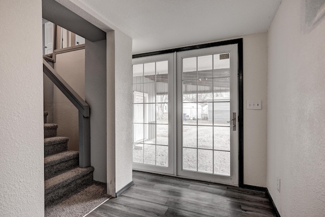 511 N E, Columbus, KS 66725 - doorway featuring a textured wall, stairs, and wood finished floors