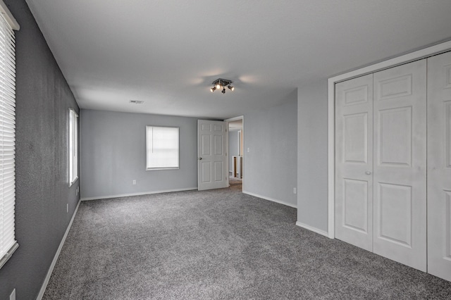 511 N E, Columbus, KS 66725 - unfurnished bedroom with carpet, baseboards, and a closet