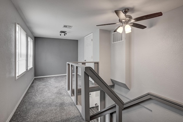 511 N E, Columbus, KS 66725 - hall featuring an upstairs landing, carpet floors, baseboards, and a textured wall