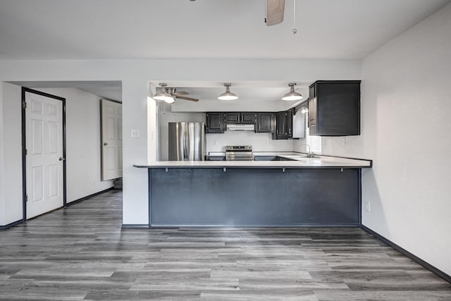 511 N E, Columbus, KS 66725 - kitchen featuring appliances with stainless steel finishes, a ceiling fan, wood finished floors, and baseboards