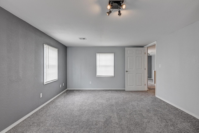 511 N E, Columbus, KS 66725 - spare room featuring carpet and baseboards