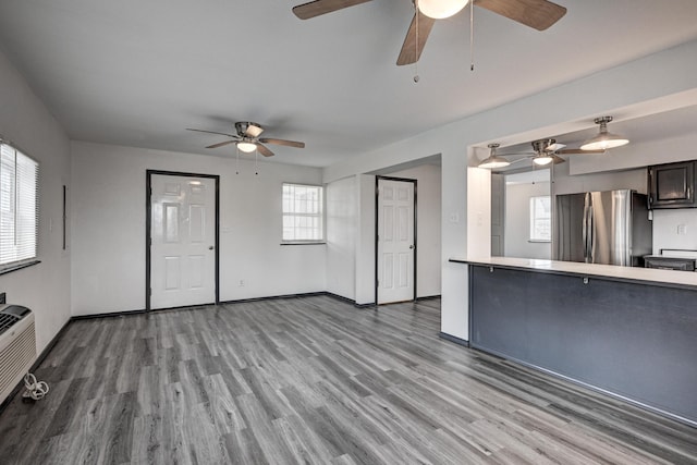 511 N E, Columbus, KS 66725 - unfurnished living room featuring a ceiling fan and wood finished floors
