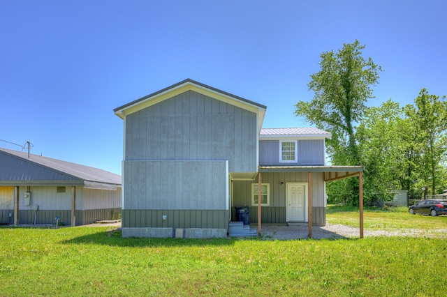 511 N E, Columbus, KS 66725 - back of house featuring a lawn and metal roof