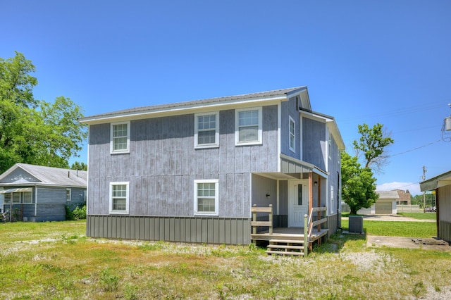 511 N E, Columbus, KS 66725 - back of house featuring metal roof and a yard