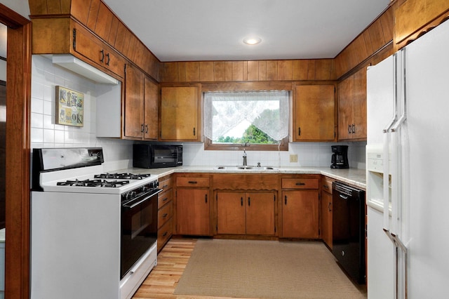 940 Carl Allen St, Mount Vernon, MO 65712 - kitchen featuring black appliances, a sink, brown cabinets, light countertops, and decorative backsplash