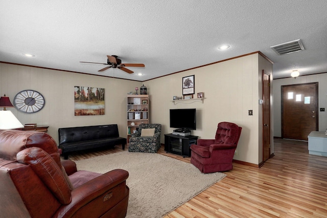 940 Carl Allen St, Mount Vernon, MO 65712 - living area featuring ceiling fan, light wood-style flooring, ornamental molding, a textured ceiling, and baseboards