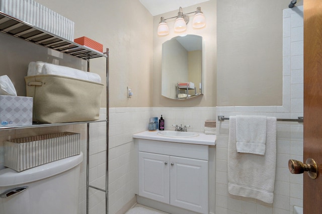 940 Carl Allen St, Mount Vernon, MO 65712 - bathroom featuring tile walls, vanity, toilet, and wainscoting
