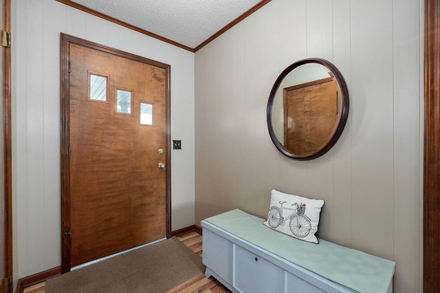 940 Carl Allen St, Mount Vernon, MO 65712 - entryway featuring ornamental molding, light wood-type flooring, a textured ceiling, and a decorative wall