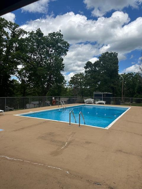 TBD Kings Cove Ln Unit 16, Reeds Spring, MO 65737 - community pool featuring a patio and view of scattered trees