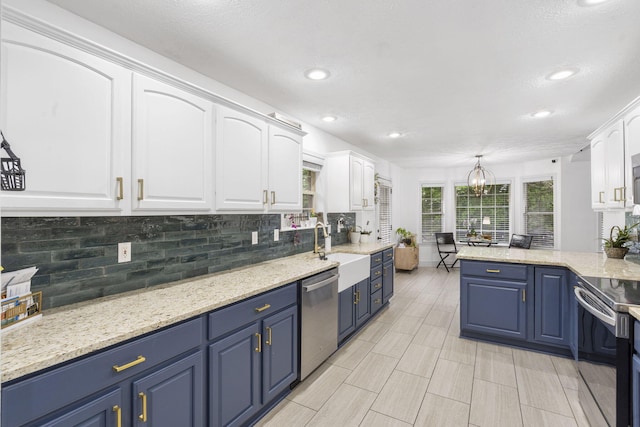 604 N Cascades Dr, Nixa, MO 65714 - kitchen featuring stainless steel appliances, blue cabinetry, white cabinetry, tasteful backsplash, and recessed lighting