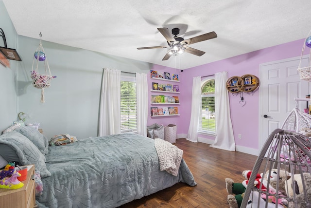 604 N Cascades Dr, Nixa, MO 65714 - bedroom with multiple windows, a textured ceiling, baseboards, wood finished floors, and ceiling fan