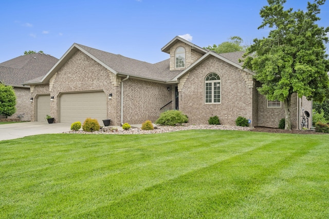 604 N Cascades Dr, Nixa, MO 65714 - view of front facade featuring an attached garage, a front yard, brick siding, and concrete driveway