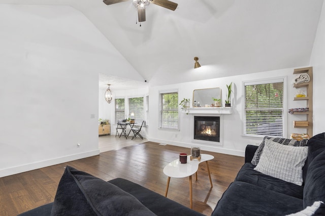 604 N Cascades Dr, Nixa, MO 65714 - living room featuring a glass covered fireplace, baseboards, a ceiling fan, wood finished floors, and high vaulted ceiling