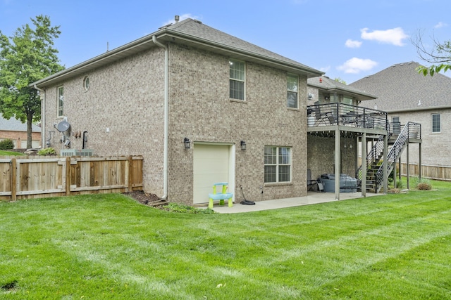 604 N Cascades Dr, Nixa, MO 65714 - back of property featuring a wooden deck, stairs, a patio area, and a garage