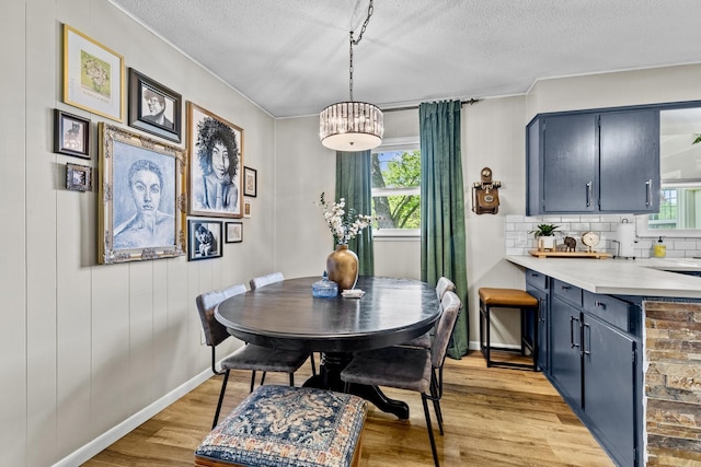 801 N Myrtle St, Pierce City, MO 65723 - dining space featuring healthy amount of natural light, light wood-type flooring, a textured ceiling, and baseboards