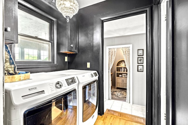 801 N Myrtle St, Pierce City, MO 65723 - washroom featuring independent washer and dryer, cabinet space, wood finished floors, and a chandelier