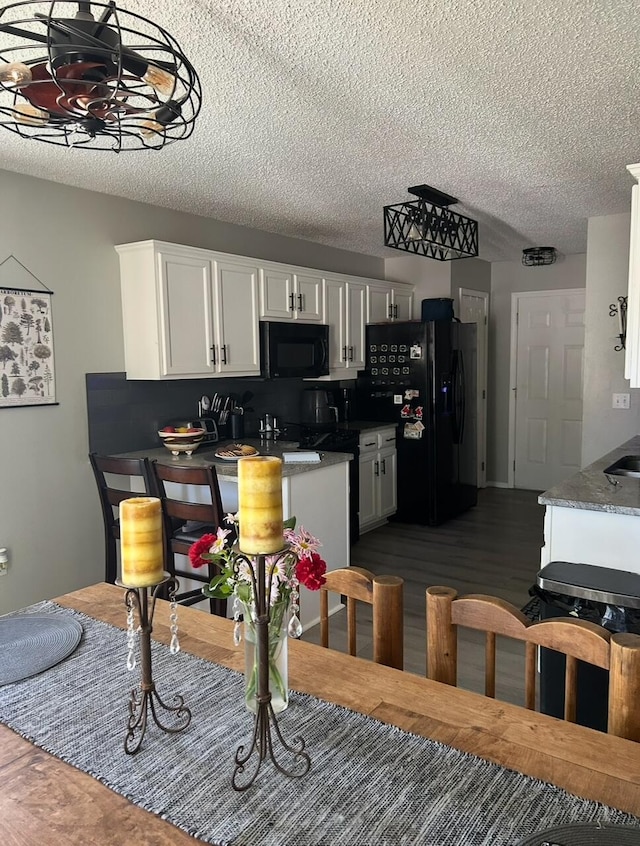 3943 W Kay Pointe Blvd, Springfield, MO 65802 - kitchen with black appliances, white cabinetry, a textured ceiling, and dark wood-style floors