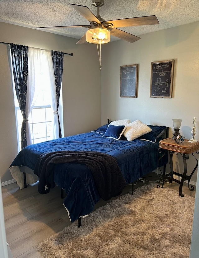 3943 W Kay Pointe Blvd, Springfield, MO 65802 - bedroom with a textured ceiling, a ceiling fan, and wood finished floors