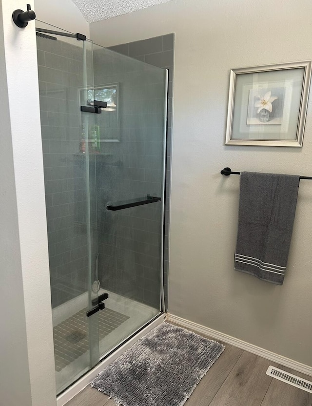 3943 W Kay Pointe Blvd, Springfield, MO 65802 - bathroom with a stall shower, wood finished floors, and baseboards