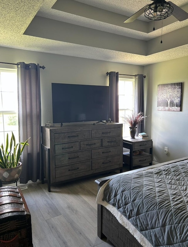 3943 W Kay Pointe Blvd, Springfield, MO 65802 - bedroom with wood finished floors, a tray ceiling, and ceiling fan