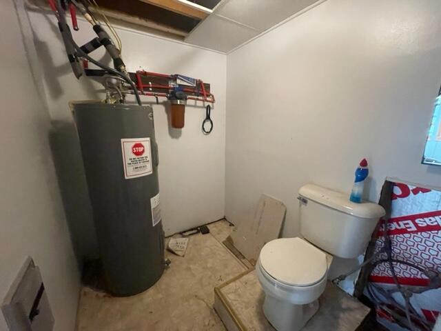 10694 Red Spring Rd, Mountain Grove, MO 65711 - bathroom with water heater, unfinished concrete floors, and toilet