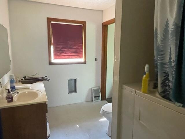 10694 Red Spring Rd, Mountain Grove, MO 65711 - bathroom featuring washing machine and dryer, vanity, toilet, and a shower with curtain