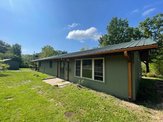 10694 Red Spring Rd, Mountain Grove, MO 65711 - rear view of property with a yard and metal roof