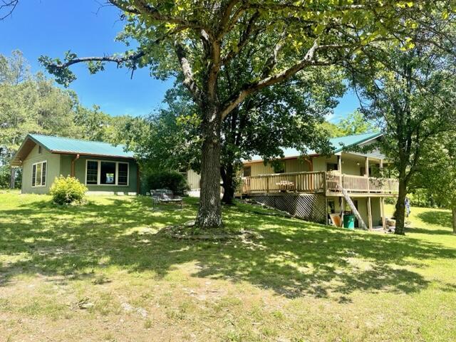 10694 Red Spring Rd, Mountain Grove, MO 65711 - view of green lawn with a wooden deck